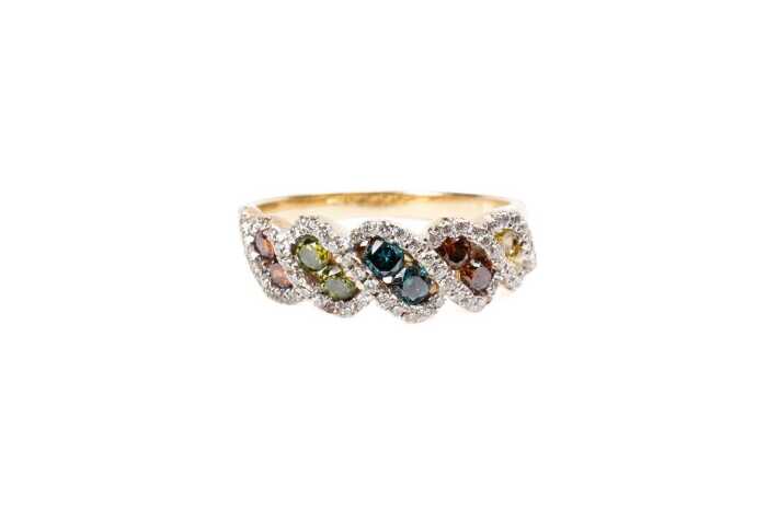 A treated coloured and white diamond ring in 14 carat yellow gold