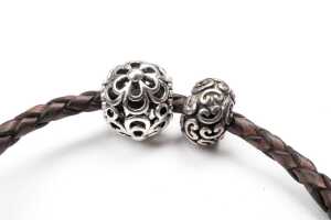 A Pandora brown leather bracelet and three retired charms in sterling silver - 3