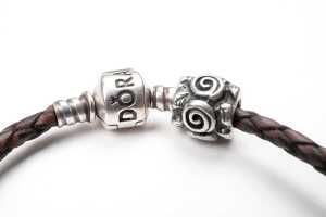 A Pandora brown leather bracelet and three retired charms in sterling silver - 4