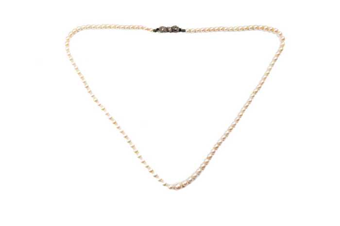 A strand of graduated white cultured pearls to a German 835 silver marcasite clasp.