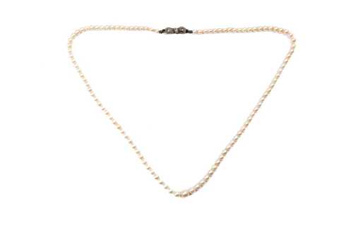 A strand of graduated white cultured pearls to a German 835 silver marcasite clasp.