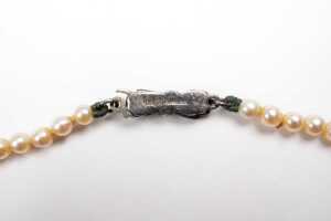 A strand of graduated white cultured pearls to a German 835 silver marcasite clasp. - 5