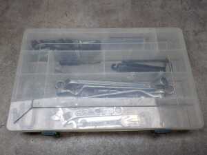 Green hardcase tackle box with tools and fishing accessories - 3