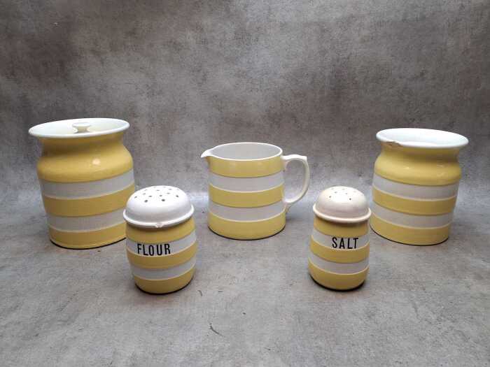 Five yellow and white ceramic Cornish Kitchenware, A/F