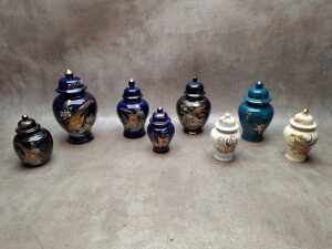 Eight Oriental ginger jars including applied gilt decoration