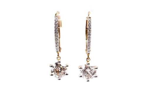 A pair of diamond earrings in 18 carat yellow gold