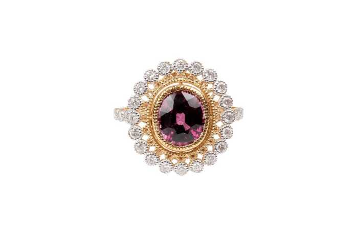 A garnet and diamond ring in 14 carat yellow gold