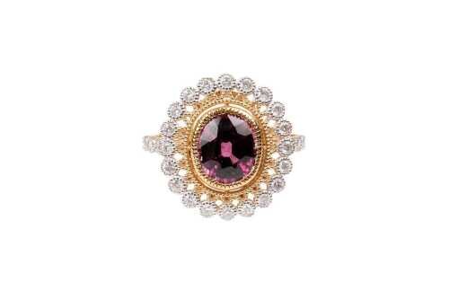 A garnet and diamond ring in 14 carat yellow gold