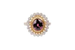 A garnet and diamond ring in 14 carat yellow gold