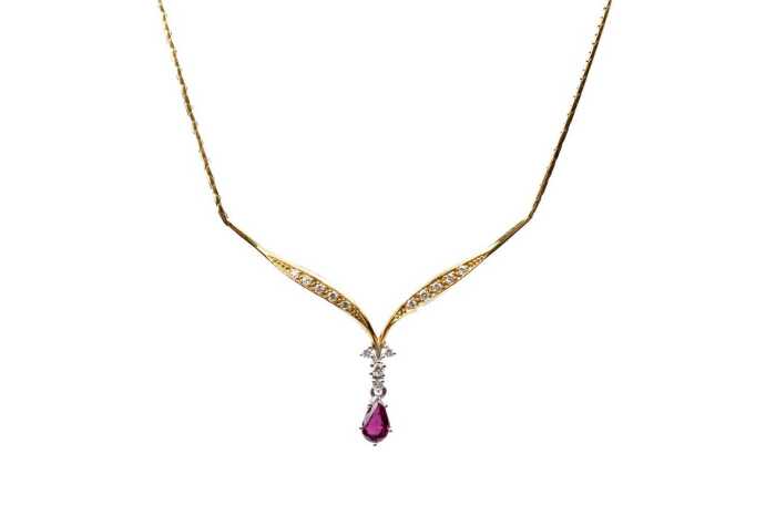A ruby and diamond necklace in 18 carat yellow gold