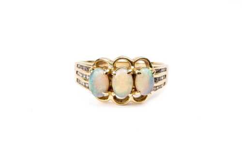 A vintage opal and diamond ring in 14 carat yellow gold