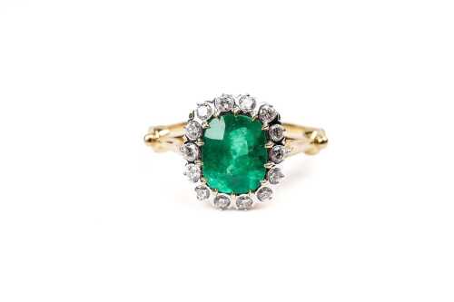 A Colombian emerald and diamond ring in 18 carat yellow gold