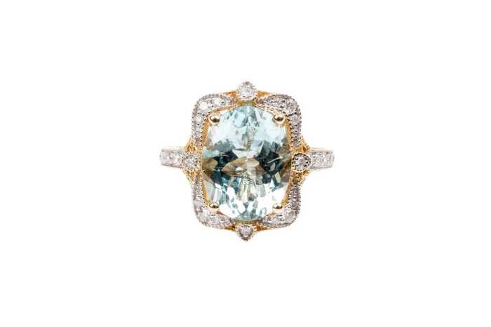 An aquamarine and diamond ring in 14 carat yellow gold