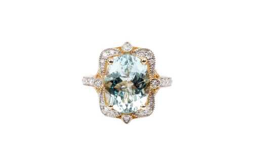 An aquamarine and diamond ring in 14 carat yellow gold