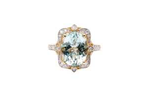 An aquamarine and diamond ring in 14 carat yellow gold