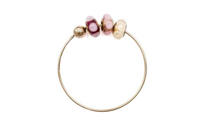 A Pandora bangle with three Murano glass charms in 14 carat yellow gold
