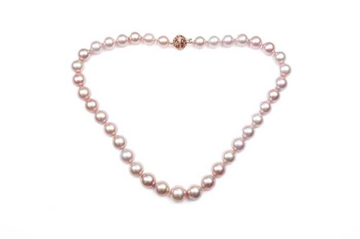 A strand of pink freshwater pearls to a 14 carat rose gold diamond clasp