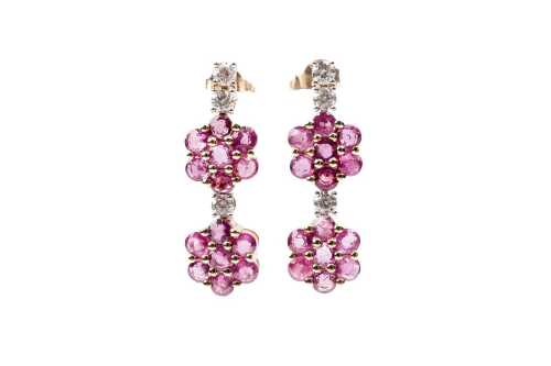 A pair of pink sapphire and diamond earrings in 14 carat yellow gold