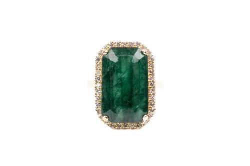 An emerald and diamond ring in 18 carat yellow gold