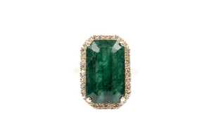 An emerald and diamond ring in 18 carat yellow gold