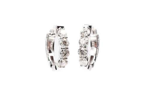 A pair of diamond hoops in 14 carat white gold