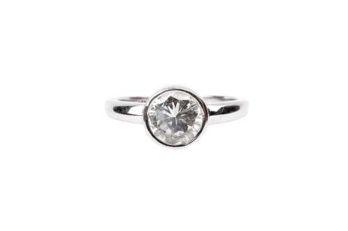 A bezel set solitaire in 18ct white gold