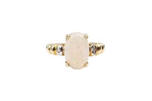 An opal and diamond ring in 14 carat yellow gold