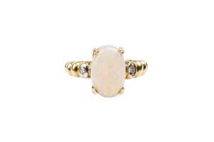 An opal and diamond ring in 14 carat yellow gold