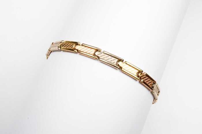 An Italian bracelet in 18 carat three tone gold