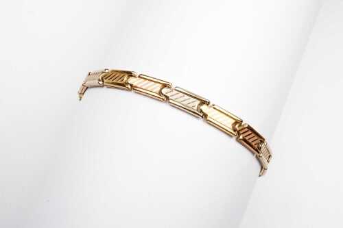 An Italian bracelet in 18 carat three tone gold