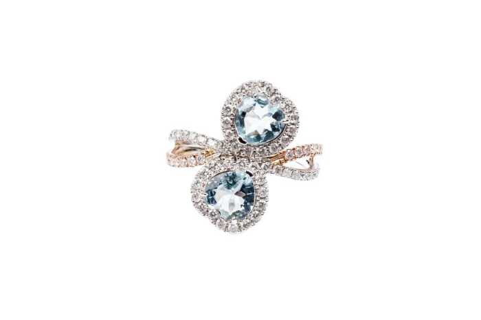 An aquamarine and diamond ring in 14 carat white and rose gold