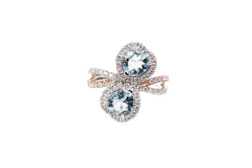 An aquamarine and diamond ring in 14 carat white and rose gold