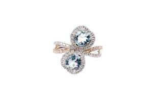 An aquamarine and diamond ring in 14 carat white and rose gold