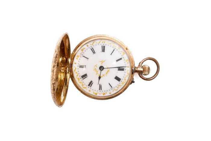 An antique pocket watch in 14 carat yellow gold