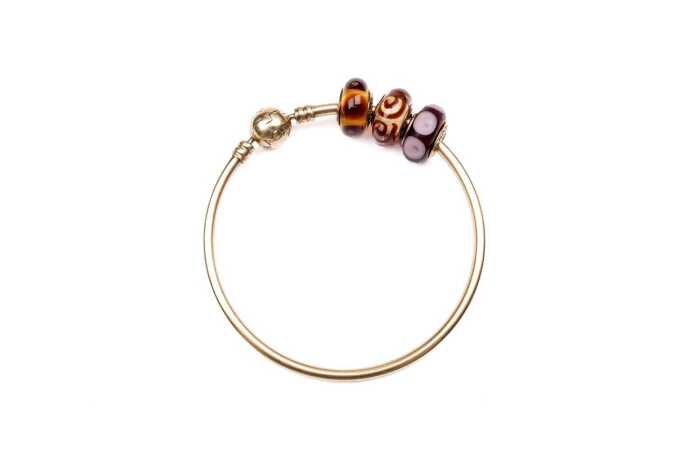 A Pandora bangle with three Murano glass charms in 14 carat yellow gold