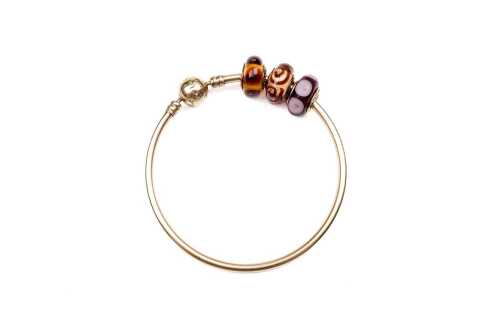 A rare Pandora bangle with three Murano glass charms in 14 carat yellow gold