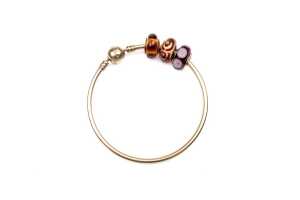 A Pandora bangle with three Murano glass charms in 14 carat yellow gold