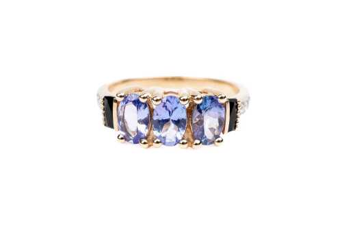 A tanzanite, diamond, and onyx ring in 9 carat yellow gold