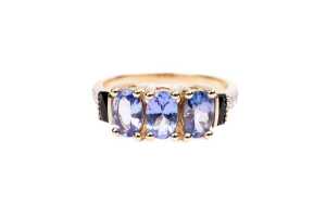 A tanzanite, diamond, and onyx ring in 9 carat yellow gold