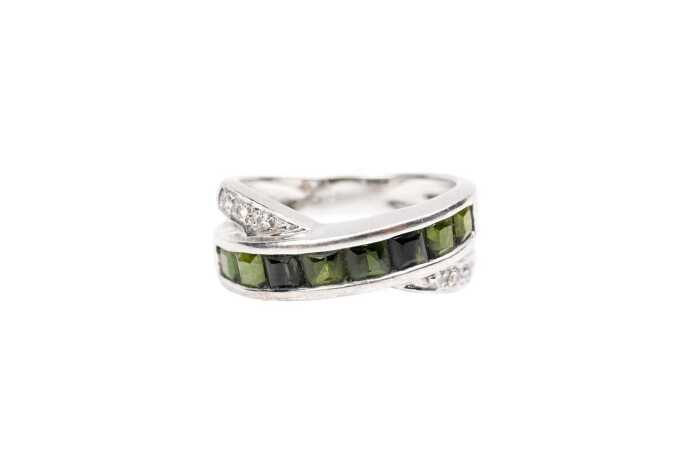 A green tourmaline and diamond ring in 18 carat yellow gold