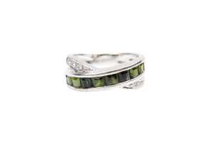 A green tourmaline and diamond ring in 18 carat yellow gold