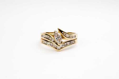 A diamond ring set in 18 carat yellow gold