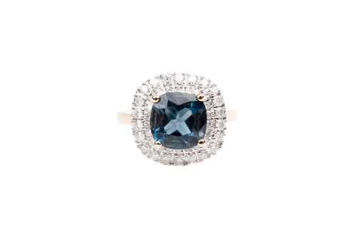 A blue topaz and diamond ring in 9 carat yellow gold