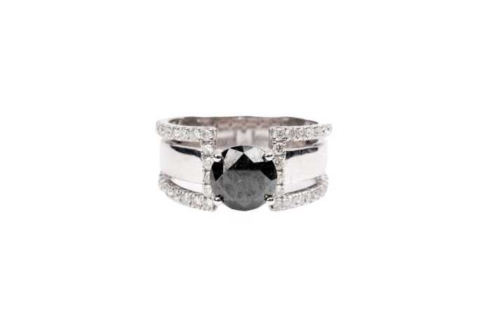 A black and white diamond ring in 14 carat white gold