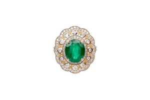 An emerald and diamond ring in 14 carat yellow gold