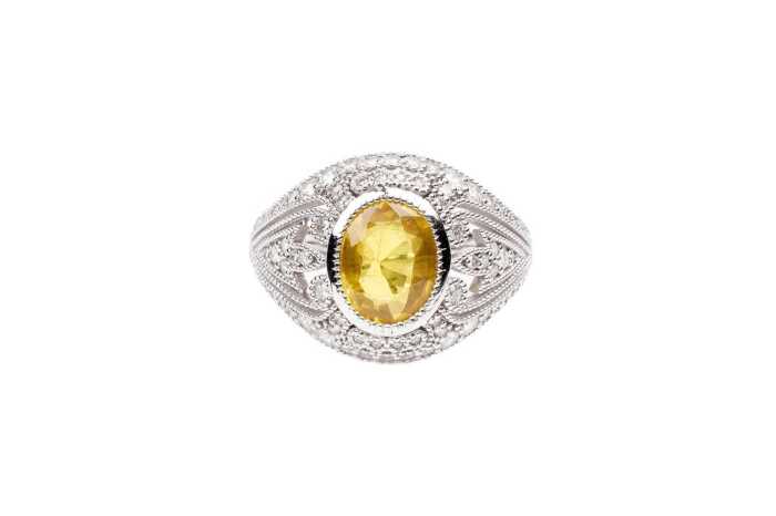 A yellow sapphire and diamond ring in 14 carat white gold