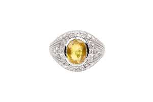 A yellow sapphire and diamond ring in 14 carat white gold