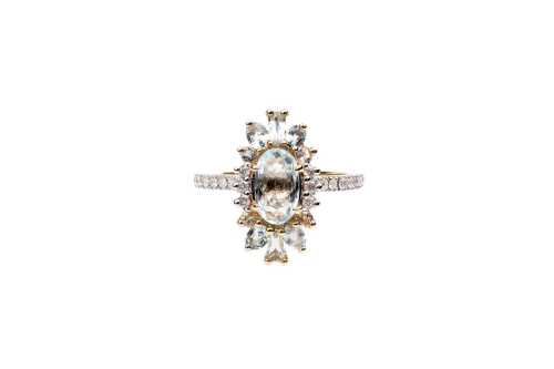 An aquamarine and diamond ring in 9 carat yellow gold