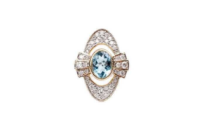 An aquamarine and diamond ring in 14 carat yellow gold
