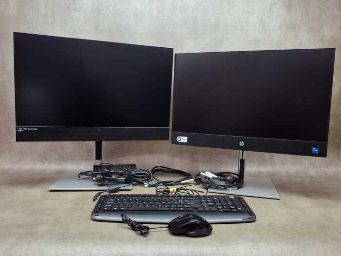 HP ProOne 440 All-in-One desktop computer with an additional monitor, mouse, and keyboard
